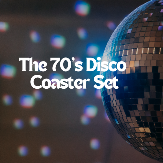 Titles say The 70&#39;sDisco Coaster Set. The background is blurry with spots of lights coming through from the disco ball which isonthe right side of the image.